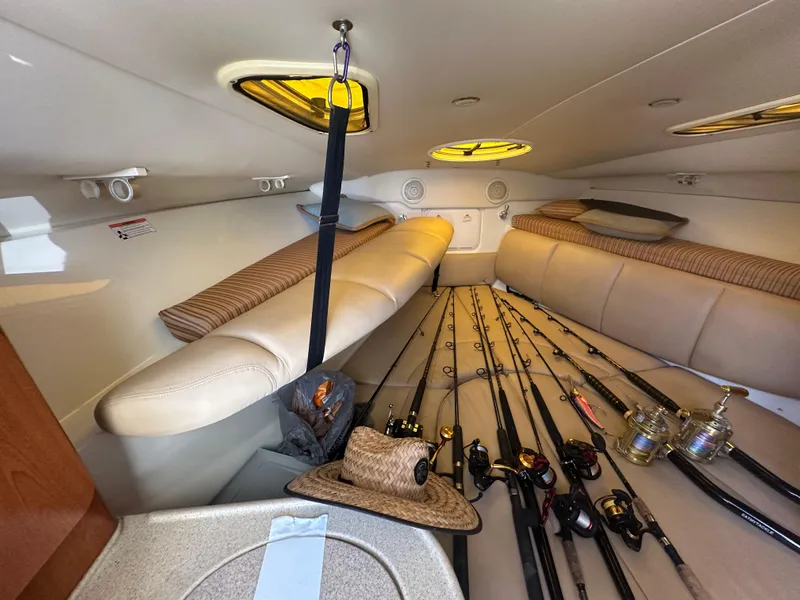 Slide: The Image of 2007 Hydra-Sports Vector 3300 VX cabin with fishing rods and hat on beige seating. - 23