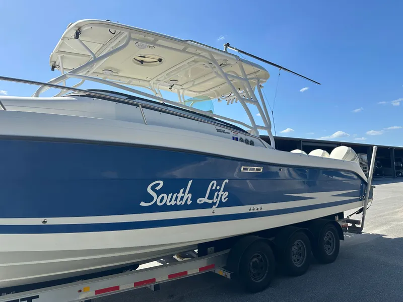 Slide: The Image of 2007 Hydra-Sports Vector 3300 VX boat on trailer, blue and white, named "South Life." - 6