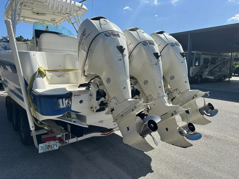 Slide: The Image of 2007 Hydra-Sports Vector 3300 VX boat with triple outboard engines, parked on a trailer. - 8