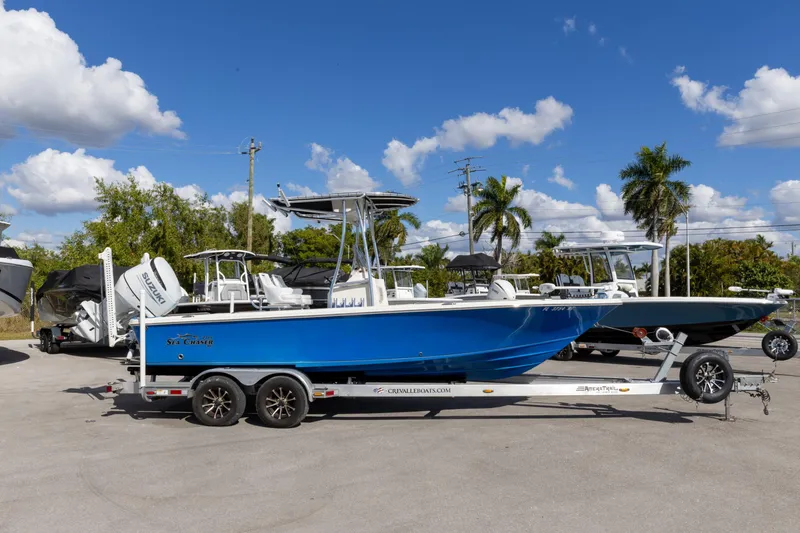 The Image of 2018 Sea Chaser 23 LX Bay Runner boat on trailer under clear blue sky. - 0