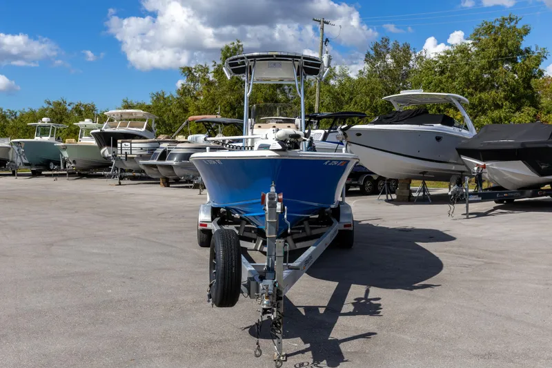 Slide: The Image of 2018 Sea Chaser 23 LX Bay Runner boat on trailer, surrounded by other boats. - 11