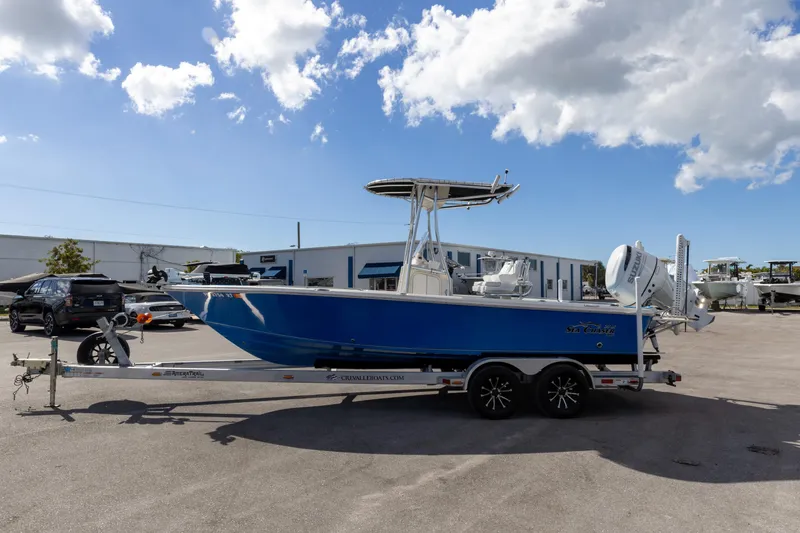 Slide: The Image of 2018 Sea Chaser 23 LX Bay Runner boat on trailer under blue sky. - 12