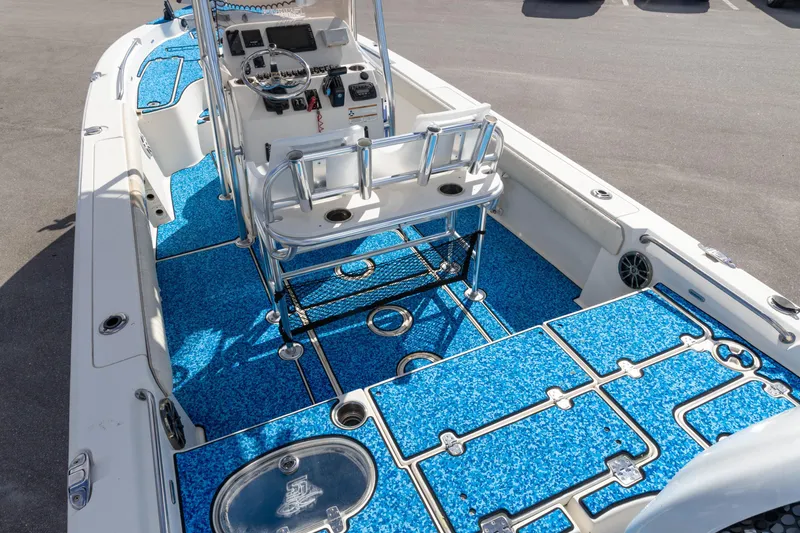 Slide: The Image of 2018 Sea Chaser 23 LX Bay Runner boat interior with blue flooring and steering console. - 5