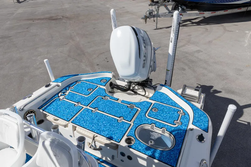 Slide: The Image of 2018 Sea Chaser 23 LX Bay Runner boat with blue deck and Suzuki outboard motor. - 6