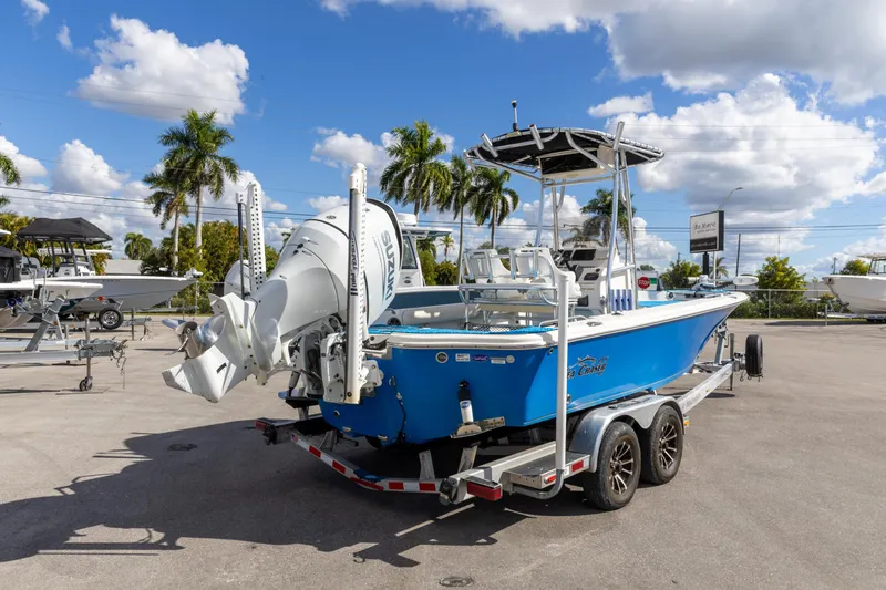 Slide: The Image of 2018 Sea Chaser 23 LX Bay Runner boat on trailer, parked outdoors under blue sky. - 7
