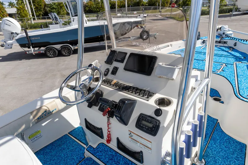 Slide: The Image of 2018 Sea Chaser 23 LX Bay Runner boat dashboard with steering wheel and controls. - 8