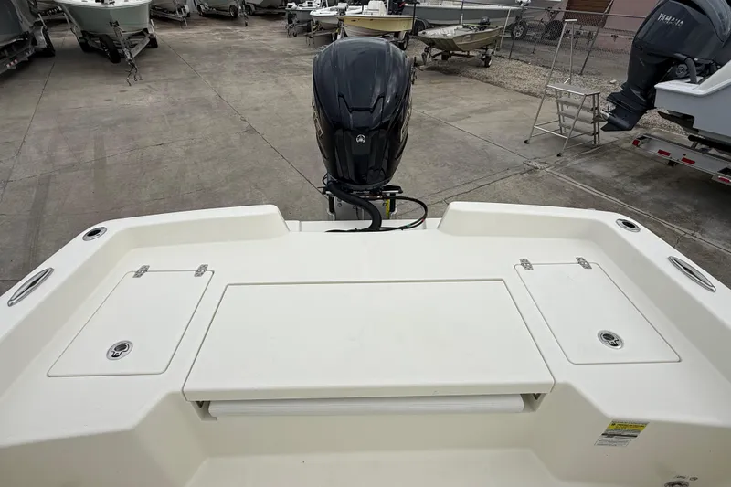 Slide: The Image of 2026 Pathfinder 2400 TRS boat with outboard motor in a marina setting. - 13