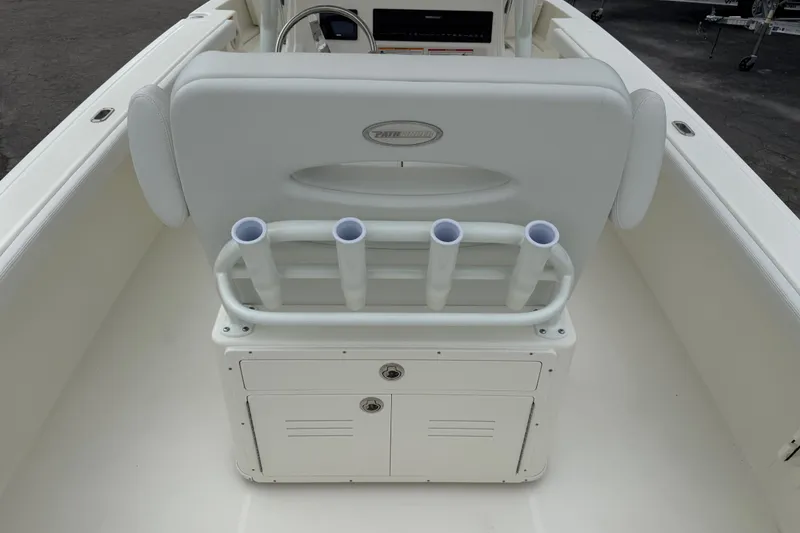 Slide: The Image of 2026 Pathfinder 2400 TRS boat interior with rod holders and storage compartment. - 14