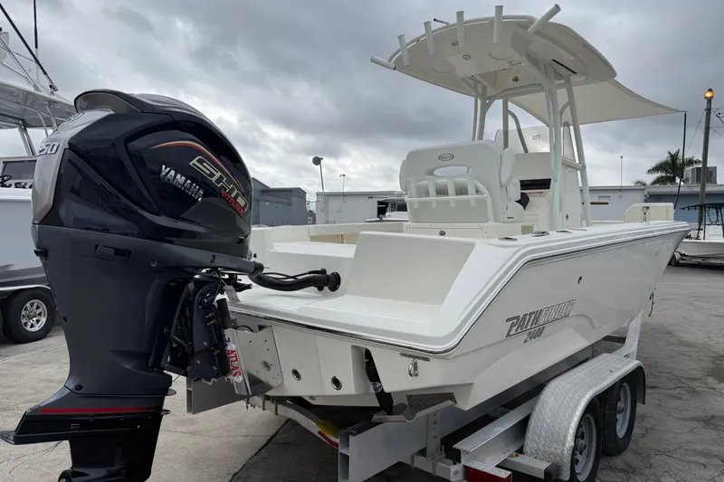 Slide: The Image of 2026 Pathfinder 2400 TRS boat with Yamaha engine on trailer, overcast sky. - 15