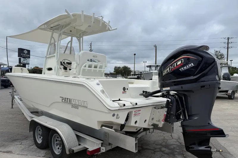 Slide: The Image of 2026 Pathfinder 2400 TRS boat with Yamaha engine on trailer, outdoor dealership setting. - 16