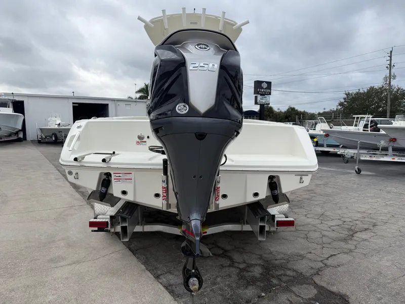 Slide: The Image of 2026 Pathfinder 2400 TRS boat with powerful 250 engine, displayed outdoors. - 18
