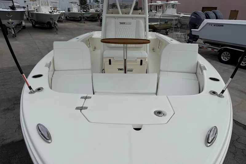 Slide: The Image of 2026 Pathfinder 2400 TRS boat with spacious seating and sleek design in a marina setting. - 20