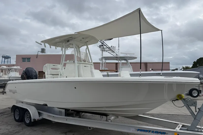 Slide: The Image of 2026 Pathfinder 2400 TRS boat on trailer, featuring canopy and sleek design. - 21