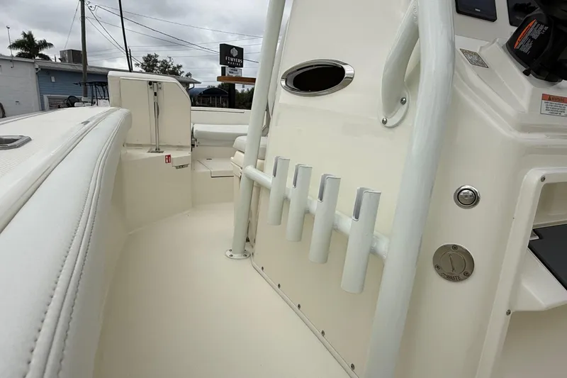 Slide: The Image of 2026 Pathfinder 2400 TRS boat interior with rod holders and control panel. - 6
