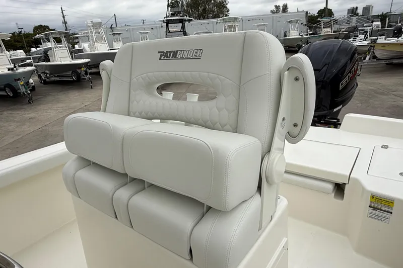 Slide: The Image of 2026 Pathfinder 2400 TRS boat seat, white leather, in a marina setting. - 9