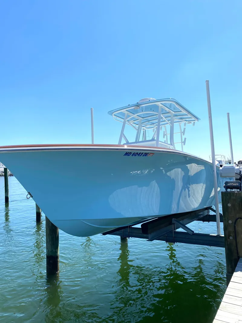 The Image of Valentino 28CC boat 2023 on a boat lift at the dock. - 0