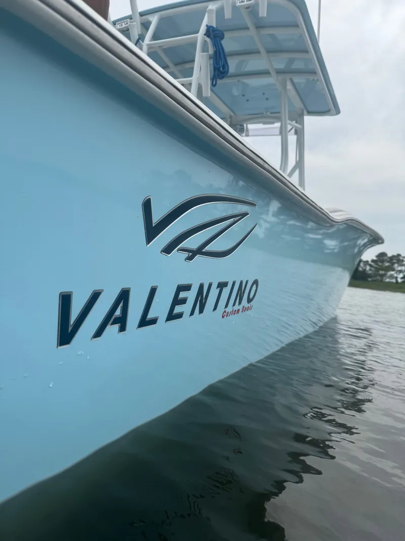 Slide: The Image of Valentino 28CC boat 2023 on calm water. - 10
