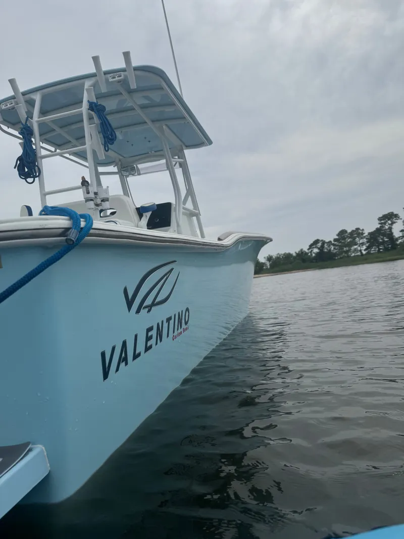 Slide: The Image of Valentino 28CC boat 2023 on calm water. - 11
