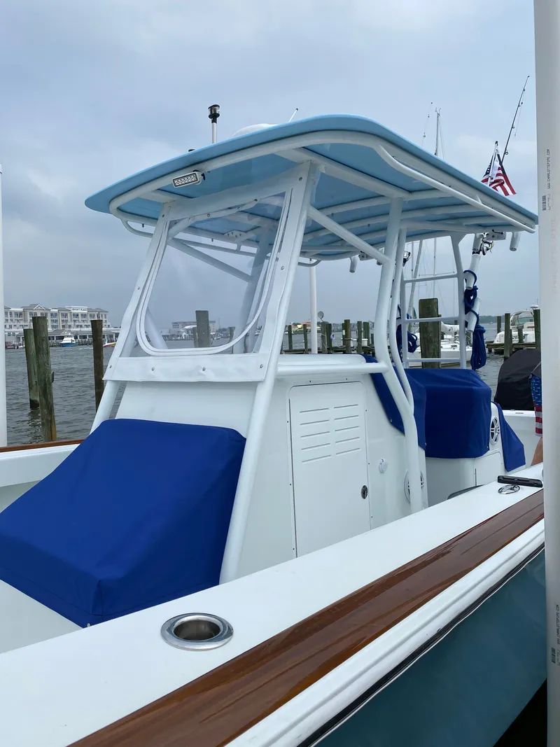Slide: The Image of Valentino 28CC boat 2023 at dock with blue covers. - 16