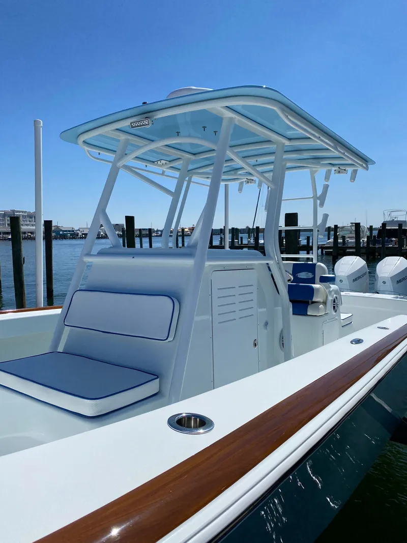 Slide: The Image of 2023 Valentino 28CC boat docked with blue canopy. - 17