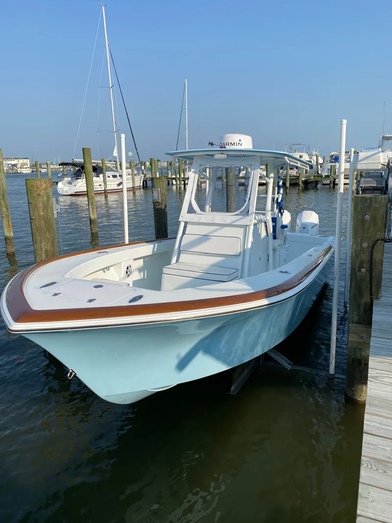 Slide: The Image of 2023 Valentino 28CC boat docked at marina. - 2