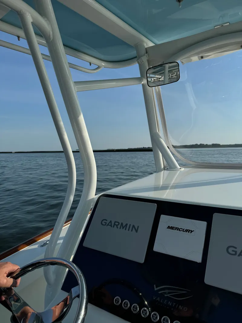 Slide: The Image of Valentino 28CC boat 2023 with Garmin and Mercury controls on calm water. - 21