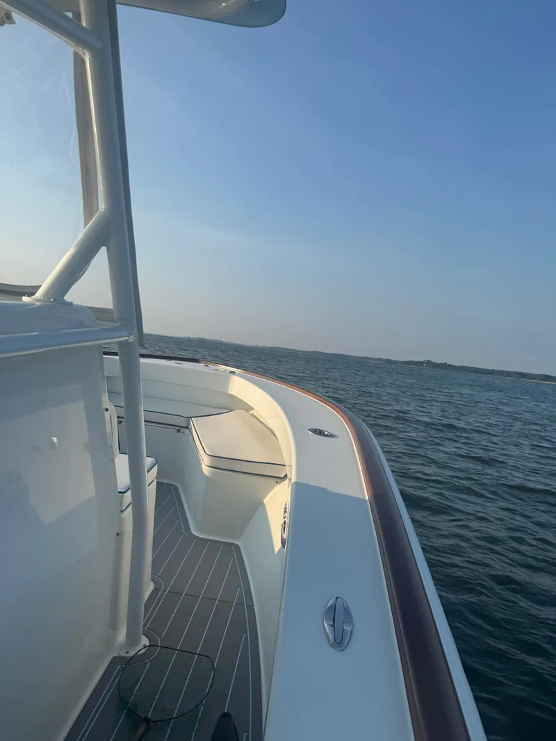 Slide: The Image of Valentino 28CC boat 2023 on calm waters at sunset. - 23