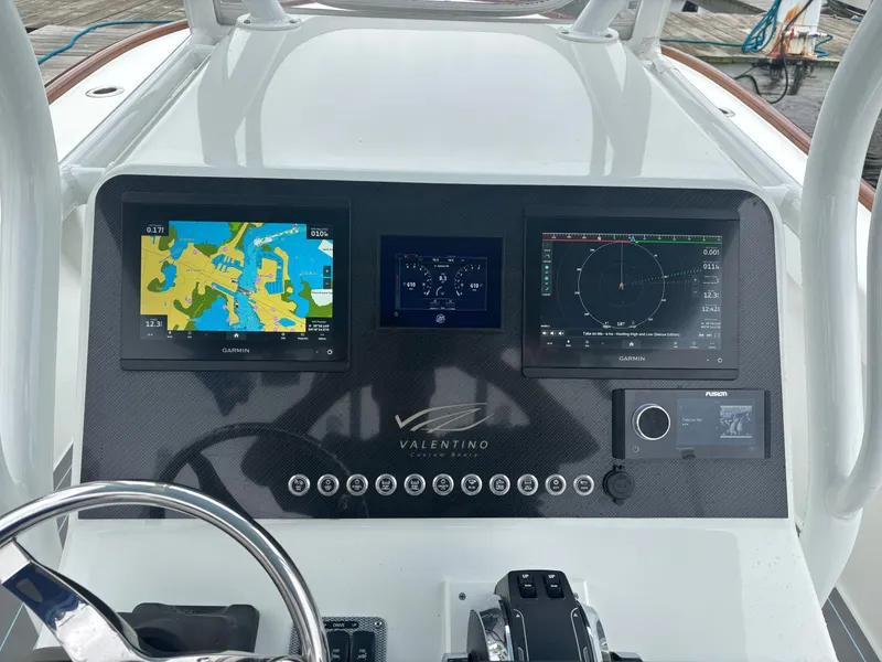 Slide: The Image of Valentino 28CC 2023 boat console with Garmin displays. - 26