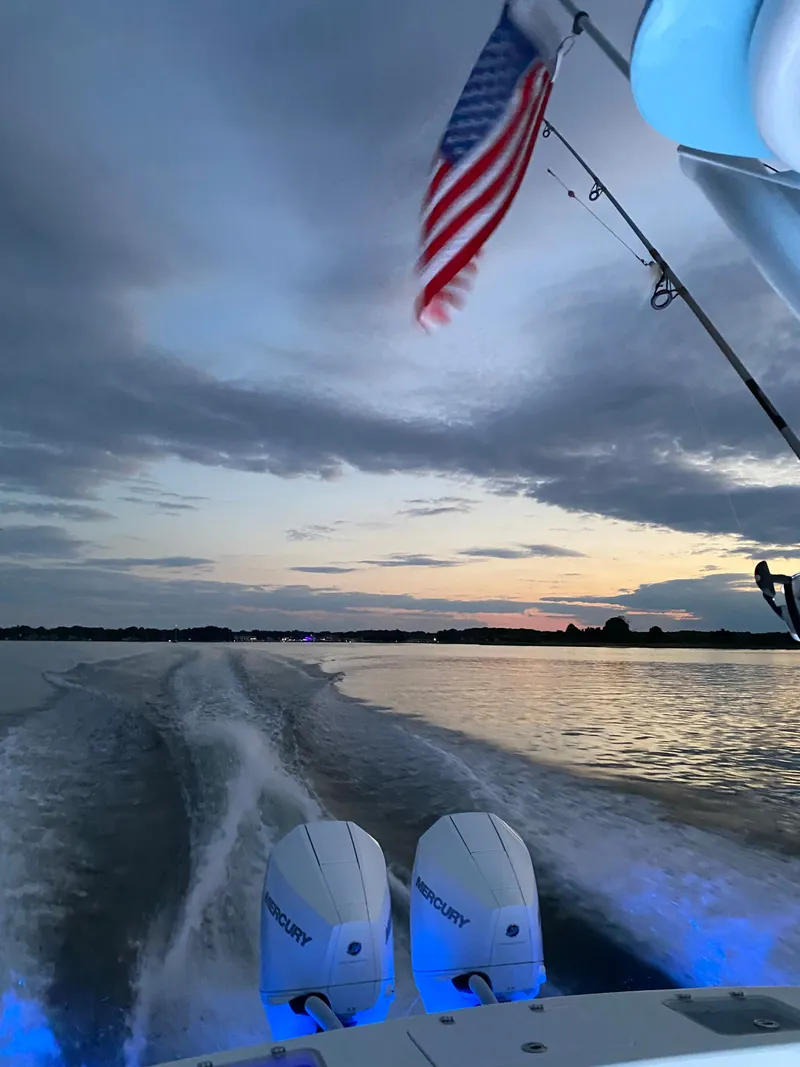 Slide: The Image of Valentino 28CC boat at sunset with American flag. - 31