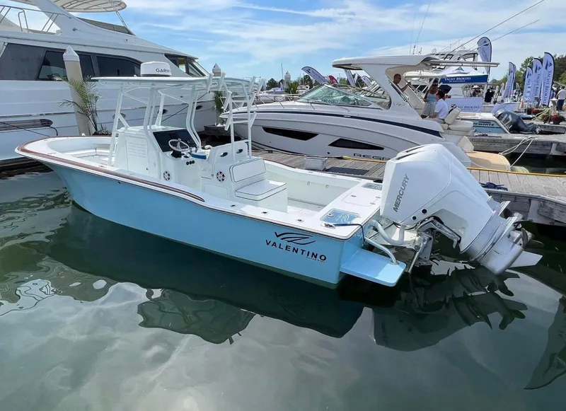 Slide: The Image of Valentino 28CC 2023 boat docked, featuring Mercury engine. - 7