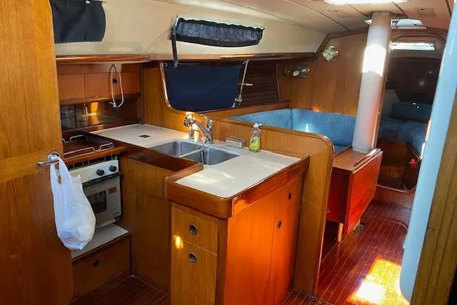 Slide: The Image of Interior of 1987 Beneteau First 375 sailboat with kitchen and seating area. - 12