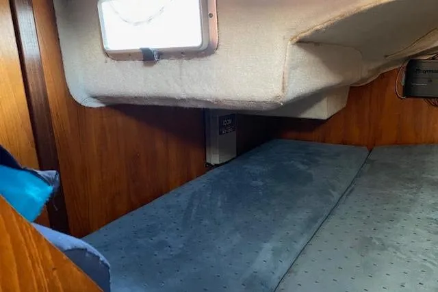 Slide: The Image of Cozy cabin interior of 1987 Beneteau First 375 sailboat with blue cushions. - 15
