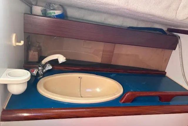 Slide: The Image of Interior of 1987 Beneteau First 375 yacht featuring a compact bathroom sink area. - 18