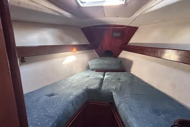 Slide: The Image of Cozy cabin interior of 1987 Beneteau First 375 sailboat with blue cushions. - 23