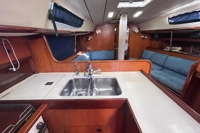 Slide: The Image of Interior of 1987 Beneteau First 375 sailboat with kitchen and seating area. - 26