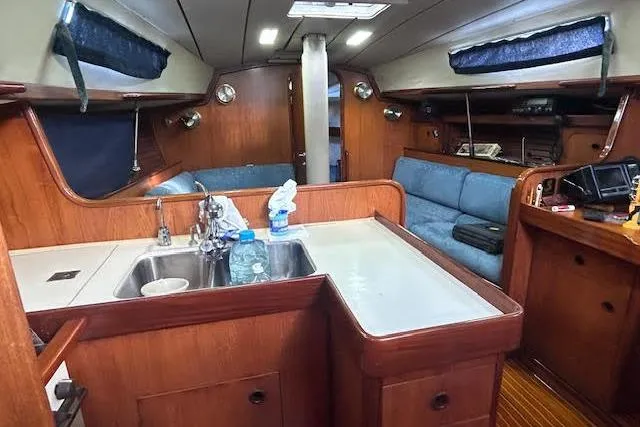 Slide: The Image of Interior of 1987 Beneteau First 375 sailboat, featuring a cozy kitchen and seating area. - 27