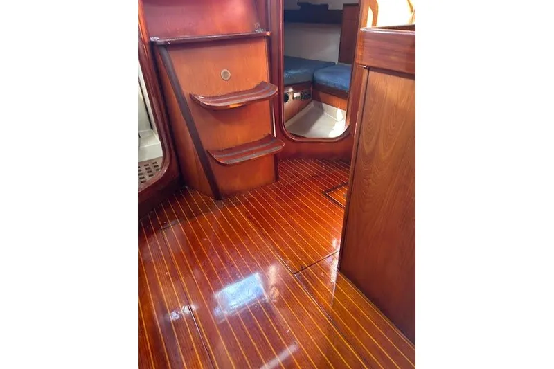 Slide: The Image of Polished wooden interior of 1987 Beneteau First 375 sailboat cabin. - 32