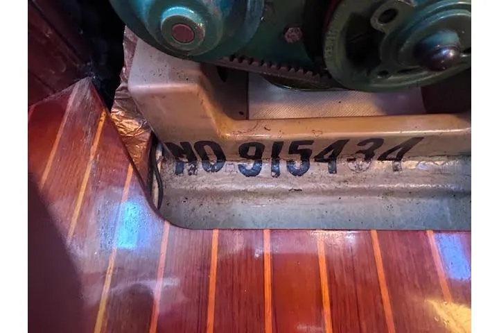 Slide: The Image of Engine compartment of 1987 Beneteau First 375 with serial number 915434 on wooden flooring. - 35