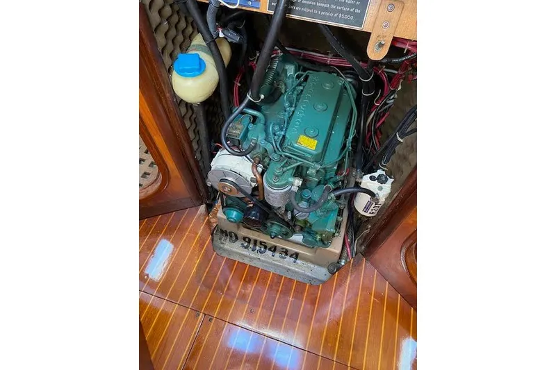 Slide: The Image of Engine compartment of a 1987 Beneteau First 375 sailboat, showcasing detailed mechanical components. - 48