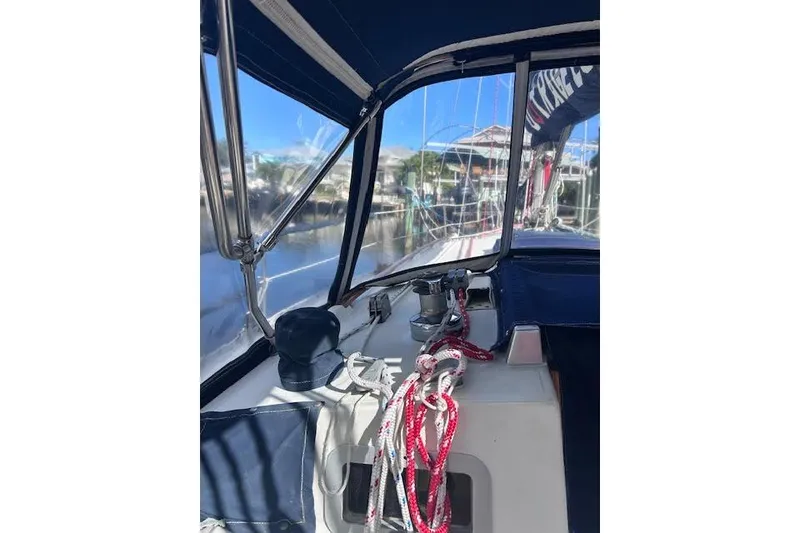 Slide: The Image of 1987 Beneteau First 375 sailboat cockpit with ropes and winch, docked in marina. - 6