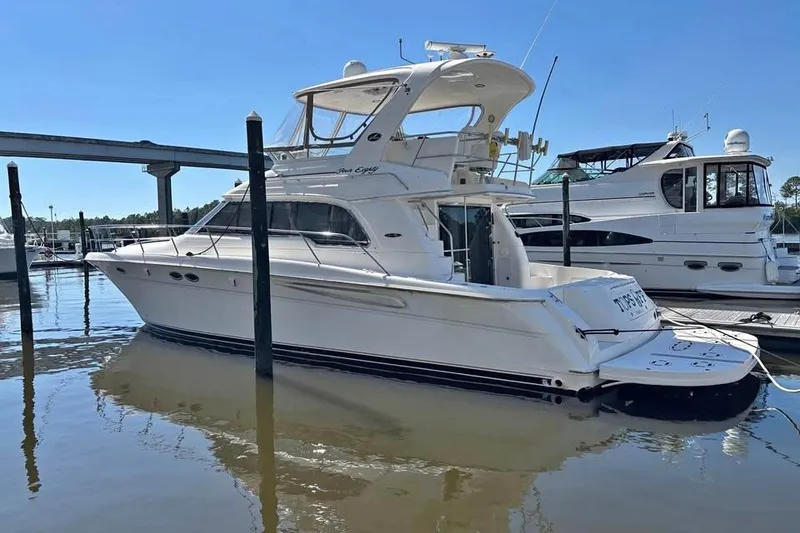 The Image of 2001 Sea Ray 480 Sedan Bridge yacht docked at marina, side view. - 0