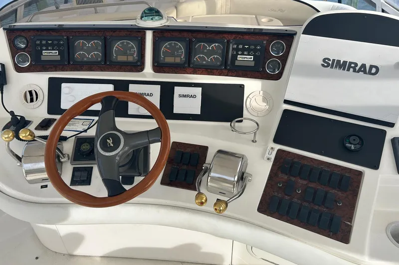 Slide: The Image of 2001 Sea Ray 480 Sedan Bridge helm with Simrad electronics and Caterpillar gauges. - 11