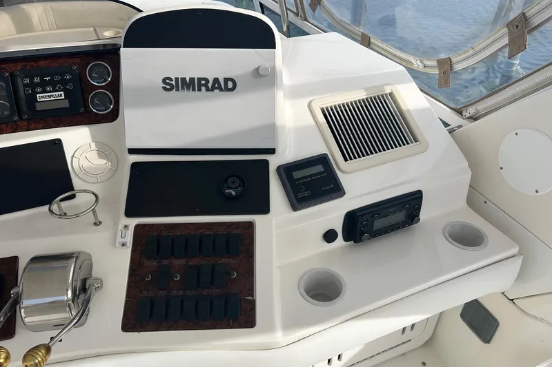 Slide: The Image of Control panel of a 2001 Sea Ray 480 Sedan Bridge with Simrad electronics. - 12