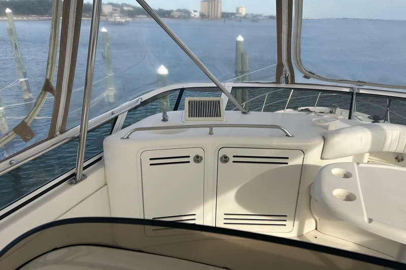 Slide: The Image of 2001 Sea Ray 480 Sedan Bridge interior with seating and water view. - 15