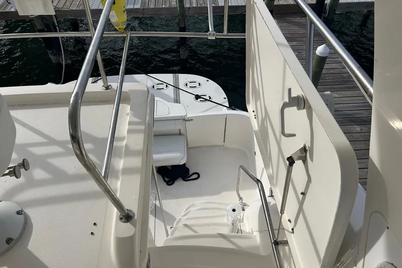 Slide: The Image of 2001 Sea Ray 480 Sedan Bridge yacht stairs and deck view at marina. - 20