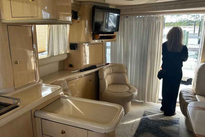 Slide: The Image of Interior of 2001 Sea Ray 480 Sedan Bridge yacht with woman looking out. - 29