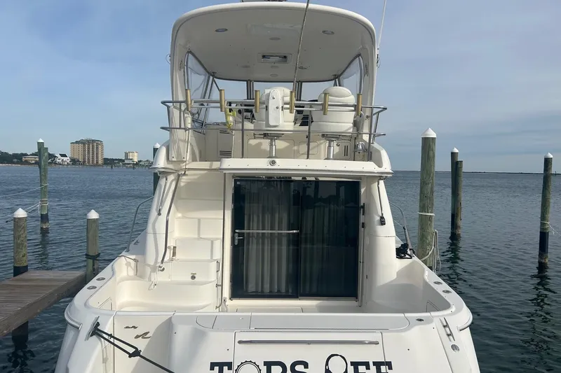 Slide: The Image of 2001 Sea Ray 480 Sedan Bridge yacht docked at marina, rear view. - 3