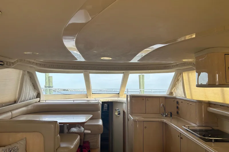 Slide: The Image of Luxurious interior of 2001 Sea Ray 480 Sedan Bridge yacht with elegant seating and kitchen area. - 34
