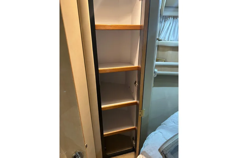 Slide: The Image of 2001 Sea Ray 480 Sedan Bridge interior shelving with wooden accents. - 37