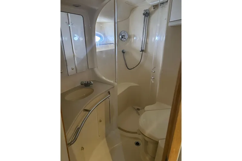Slide: The Image of Bathroom interior of 2001 Sea Ray 480 Sedan Bridge yacht, featuring shower and sink. - 41